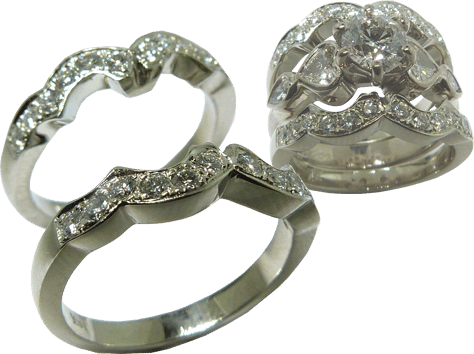 A Pair Of Wedding Bands Created To Balance And Match Contour Of Engagement Ring
