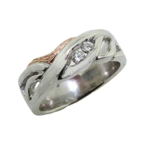 Lady's 14 karat white and rose gold dinner diamond ring, set with two round brilliant cut diamonds totaling 0.102 carats. Designed by David, the store owner.