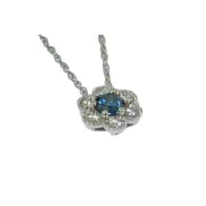 White gold floral pendant set with a blue diamond and round brilliant cut diamonds