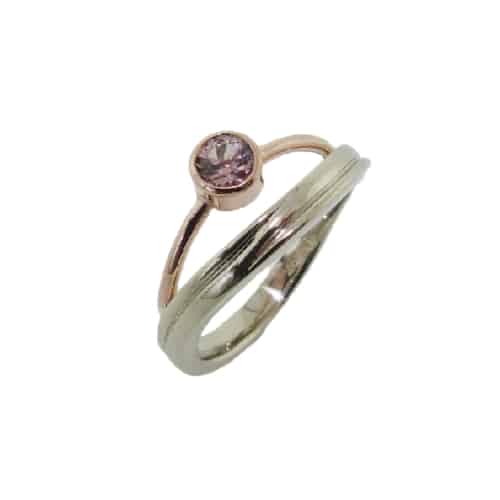 Custom white and rose gold ring set with a lotus garnet