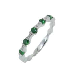Tension set in 14 karat white gold are five round brilliant cut tsavorite garnets totaling 0.30 carats. Accented with diamonds totaling 0.02 carats. This stacking band is perfect to represent January birthdays.