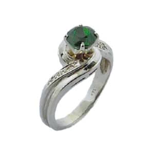 Claw set in 14 karat white gold is a 1.143 carat round brilliant cut tsavorite garnet. Accented with diamonds totaling 0.079 carats. This fashion ring is perfect to represent January birthdays.