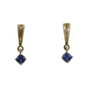 14 karat yellow gold drop earrings featuring two sapphires with a carat total weight of 0.697.