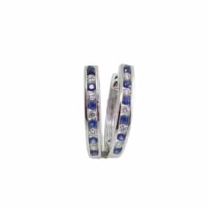 14k white gold hoop earrings channel set with 0.20ctw of sapphires and 0.13ctw, G/H, SI1-2, round brilliant cut diamonds.