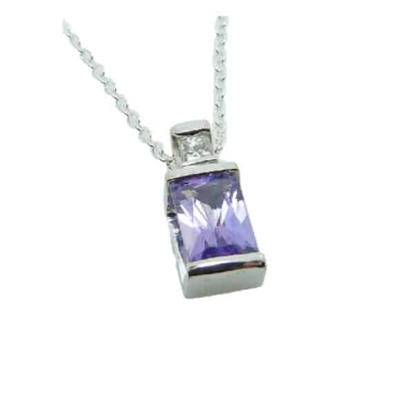 14k white gold pendant featuring a radiant cut 0.62ct purple sapphire and a 0.047ct, G/H, SI, round brilliant cut diamond.