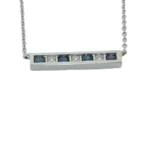 14 karat white gold channel set sapphire and diamond bar pendant. The four sapphires have a total weight of 0.13 carat and the three diamonds have a total weight of 0.02 carat. This pendant also features an adjustable 14 karat white gold chain.