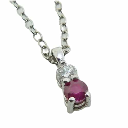 Claw set in a 14 karat white gold pendant is a simple round brilliant cut 0.269 carat ruby, paired with a 0.104 carat round brilliant cut diamond. This piece is a perfect gift to represent July birthdays and 40th anniversaries.