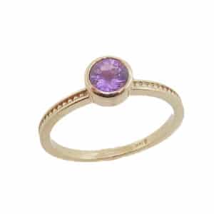 14 karat yellow gold ring bezel set with a 0.579ct purple sapphire. Wear this ring on it's own or as part of a stack!