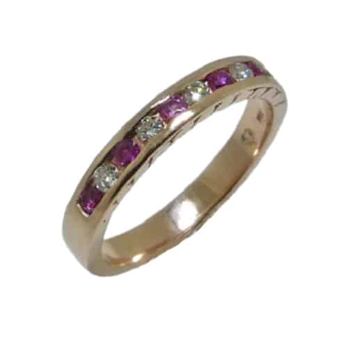14 karat rose gold band channel set with 6 = .242ctw round pink sapphires and 5 0.14ctw round brilliant cut diamonds.