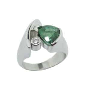 A custom fashion ring in 14 karat white gold. Showcasing a 1.90 carat trillion shaped checker board cut Green Tourmaline. Accented with a single 0.057 carat diamond. Created by our jeweler and owner, David Blitt as part of our Studio Tzela line. The perfect gift for 8th anniversaries.