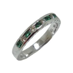 14 karat white gold band channel set with 6 = 0.22ctw emeralds and 5 = .14ctw excellent cut, F/G, VS2-SI1, round brilliant cut diamonds. Emerald is the birthstone for May.