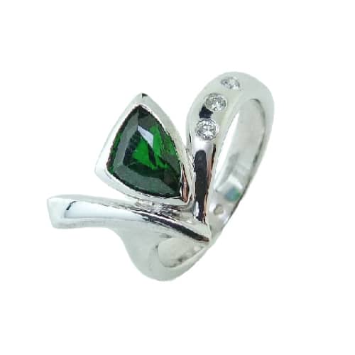 A fun fashion ring in 14 karat white gold. Showcasing a 1.026 carat fancy cut Chrome Green Tourmaline. Accented with three diamonds totaling 0.054 carats. Created by our jeweler and owner, David Blitt as part of our Studio Tzela line. The perfect gift for 8th anniversaries.