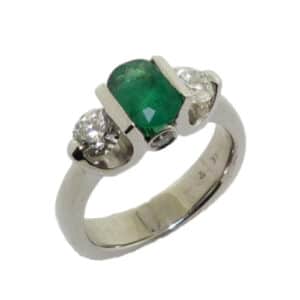 18 karat white gold ring set with a 0.92ct oval emerald and accented by 0.338ct Ideal cut,  I, SI1, Hearts on Fire round brilliant cut diamond, 0.341ct, Ideal cut, I, SI1, Hearts on Fire round brilliant cut diamond and 2 = 0.08ctw bezel set round brilliant cut diamonds. This stunning ring is a custom design by David.