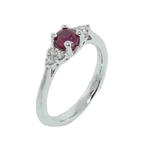 This 14 karat white gold ring, showcases a 0.622 carat Ruby. Accented with two clusters of diamonds totaling 0.14 carats. This ring is a perfect gift to represent July birthdays and 40th anniversaries.