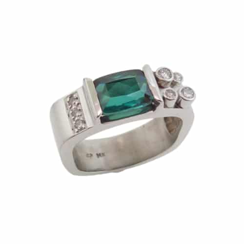 A fun fashion ring in 14 karat white gold. Showcasing a 2.41 carat fancy cut Green Tourmaline. Accented with diamonds totaling 0.12 carats. Created by our jeweler and owner, David Blitt as part of our Studio Tzela line. The perfect gift for 8th anniversaries.