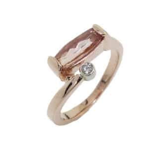 14 karat rose and white gold ring set with a 0.987ct Imperial topaz and accented with bezel set round brilliant cut diamond. This stunning ring is a custom design by David.