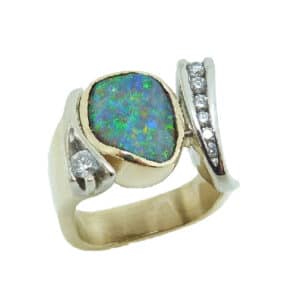 14 karat white and yellow ring set with a stunning boulder opal and accented by 7 = 0.262ctw, I/J, SI, round brilliant cut diamonds. This gorgeous ring is a custom design by David.