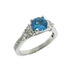 14 karat white gold ring set with a 1.12ct blue topaz and accented with 36 = 0.51ctw of round brilliant cut diamonds.