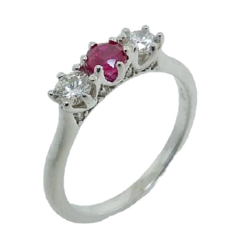 This 14 karat white gold 3-stone ring, showcases a 0.39 carat round brilliant cut Ruby. The two side diamonds total 0.338 carats and accented in the profiles of the ring are diamonds totaling 0.046 carats. This ring which resembles the past, present and future is a perfect gift to represent July birthdays and 40th anniversaries.