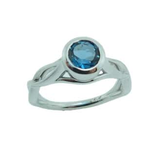14 karat white gold open twist design ring bezel set with a 0.97ct London Blue Topaz.