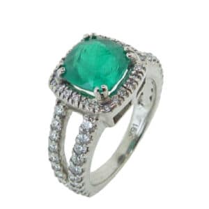 14 karat white gold split shank halo ring set with a 2.31ct emerald and accented by 0.97ctw G/H, SI1-2, round brilliant cut diamonds. Emerald is the birthstone for May.