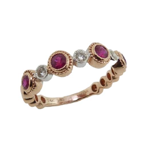 A fun 14 karat rose and white gold bubble design stacking ring, showcasing four Rubies totaling 0.57 carats. Alternating with three diamonds totaling 0.12 carats. This piece is a perfect gift to represent July birthdays and 40th anniversaries.