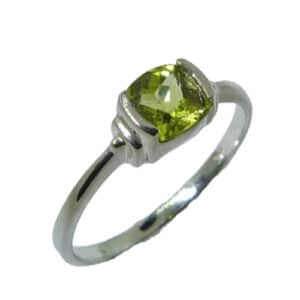 A fun little ring in 14 karat white gold. Showcases a 0.80 carat cushion cut Peridot. This piece is a perfect gift to represent August birthdays and 20th anniversaries.