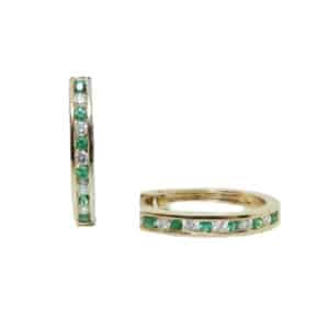 14 karat yellow gold hoops earrings set with 0.14ctw of emeralds and 0.13ctw of diamonds. Emerald is the birthstone for May.