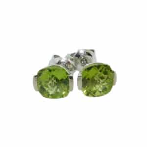 A pair of 14 karat white gold stud earrings, Showcasing 6mm cushion checker board cut Peridots. A perfect gift to represent August birthdays and 20th anniversaries.