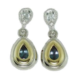 14 karat white and yellow gold vintage style drop earrings set with 2 = 0.53ctw Alexandrite and 2 = 0.12ctw round brilliant cut diamonds.