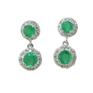 14 karat white gold halo earrings set with 4 = 0.45ctw emeralds and 40 = 0.18ctw, G/H, SI, round brilliant cut diamonds. Emerald is the birthstone for May.