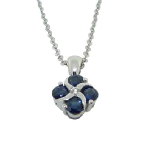 14 karat white gold flower design pendant featuring sapphires and accented with a diamond. This pendant also comes with a 14 karat chain.