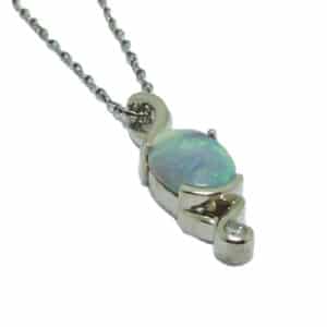 14 karat white gold pendant set with a 1.648ct opal and accented with a bezel set 0.65ct, I/J, I1, round brilliant cut diamond. This stunning pendant is a custom design by David.
