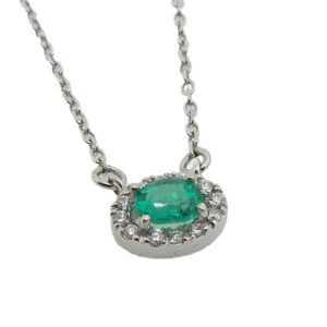 14 karat white gold pendant set with a 0.18ct oval emerald and accented with a halo of 0.05ctw. This pendant comes with an 18" chain. Emerald is the birthstone for May.