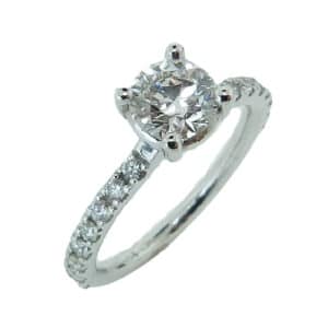 18 karat white gold solitaire engagement ring featuring a 0.766ct F, SI1 round brilliant cut diamond by Hearts on Fire. This stunning ring is accented by 16 = 0.31ctw F/G, VS/SI round brilliant cut diamonds on the band.