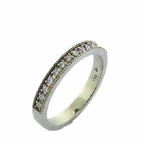 14 karat white gold wedding band set with ideal cut, round brilliant cut diamonds by Hearts On Fire, 0.21 carat total weight, SI1, G/H. This band is accented with milgrain engraving.