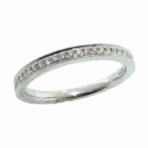 18 karat white gold 'Identity' wedding band set with ideal cut, round brilliant cut diamonds by Hearts On Fire, 0.20 carat total weight, G/H, VS-SI. This ring features beautiful milgrain engraving. This style is now discontinued.