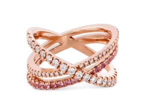 18K rose gold Harley Wrap Power Band by Hayley Paige for Hearts on Fire featuring ideal cut Hearts on Fire diamonds and pink sapphires. This ring is also available in all diamonds and as an engagement ring. This unique ring is available in 18K white, yellow and rose gold as well as platinum. Each ring by Hayley Paige for Hearts on Fire features a pink sapphire (in Hayley's favourite shade of pink) on the inside of the band.