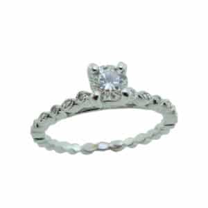 14 karat solitaire engagement ring featuring a 0.33ct G, IF round brilliant cut diamond and accented by 12 = 0.04ctw round brilliant cut diamonds. This ring has milgrain engraving.