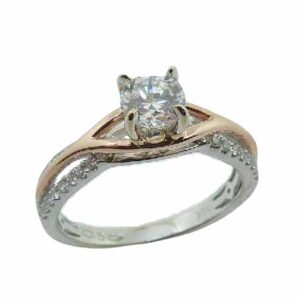 14 karat white and rose twist design solitaire engagement ring featuring 38 = 0.20ctw G/H, SI round brilliant cut diamonds. This unique design is a great alternative to a traditional solitaire ring. Priced without a center gemstone. Let us find you the perfect center that fits your tastes and budget!