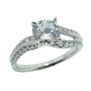 14 karat white multi level wave design solitaire engagement ring accented by 26 = 0.33ctw round brilliant cut diamonds.