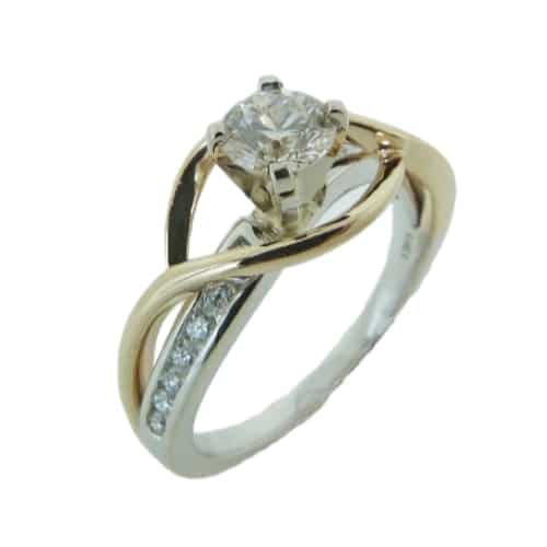 14 karat white and yellow gold solitaire engagement ring featuring a 0.55ct excellent cut good cut J/K, SI2/I1 round brilliant cut diamond accented by 14 = 0.20ctw H/I, SI2 round brilliant cut diamonds. This ring is a stunning alternative to a traditional solitaire.