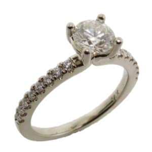 14 karat solitaire engagement ring featuring a 0.65ct H, SI2 round brilliant cut diamond accented by 16 = 0.25ctw round brilliant cut diamonds.