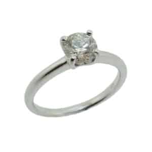 14 karat white solitaire engagement ring featuring a 0.70ct I, SI2 round brilliant cut diamond accented by 0.09ctw G/H, SI round brilliant cut diamonds. This stunning ring is a modern alternative to a traditional solitaire.