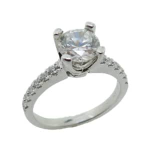 14 karat white gold solitaire engagement ring featuring 12 = 0.19ctw round brilliant cut diamonds.