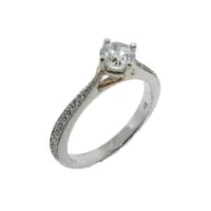 14 karat white and rose compass design solitaire engagement ring featuring 20 = 0.14ctw G/H, SI round brilliant cut diamonds. This unique design is a great alternative to a traditional solitaire ring. Priced without a center gemstone. Let us find you the perfect center that fits your tastes and budget!