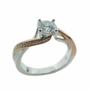 14K White gold engagement ring with a rose gold accents by Frederic Sage set with a 0.50ct round CZ and pave set on the band with 32 round brilliant cut diamonds, 0.11cttw, G/H, VS-SI. Available in 14K gold, 18K gold, or platinum. This ring can be made in any combination of white, pink or yellow gold and can be customized to accommodate different size and shape diamonds, by special order. Priced without a center gemstone. Let us find you the perfect center that fits your tastes and budget!