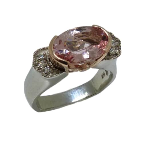 A vintage inspired fashion ring in 14 karat white and rose gold. Showcasing a 2.577 carat oval shaped Morganite. Accented with diamonds totaling 0.089 carats. Created by our jeweler and owner, David Blitt as part of our Studio Tzela line.