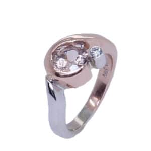 A sweet 14 karat rose and white gold custom ring. Showcasing a 0.764 carat round brilliant cut Morganite. Accented with a single 0.046 carat diamond. Created by our jeweler and owner, David Blitt as part of our Studio Tzela line. The perfect gift for a subtle hint of colour, but still plenty of sparkle.