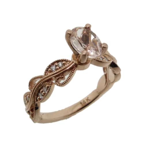 A floral designed ring in 14 karat rose gold. Showcasing a 0.598 carat oval shaped Morganite. Accented with diamonds totaling 0.12 carats. A beautifully dainty piece that can be used for an engagement ring or a fashion ring.